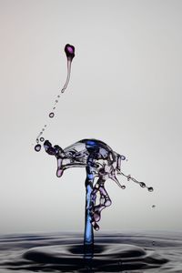 Close-up of water splashing against white background