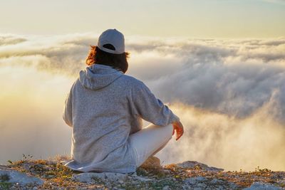 Rear view of women sitting on mountain