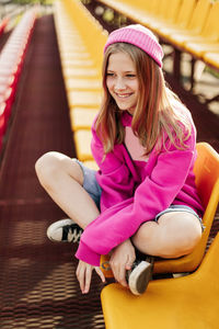 Portrait of young woman sitting on sofa at home