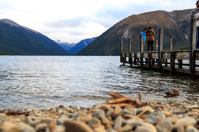 Scenic view of lake and mountains against sky