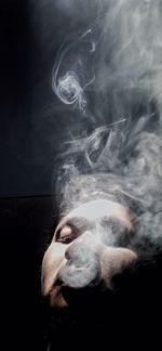 Digital composite image of man smoking cigarette