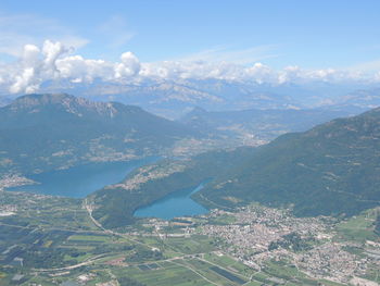 Aerial view of city and mountains against sky