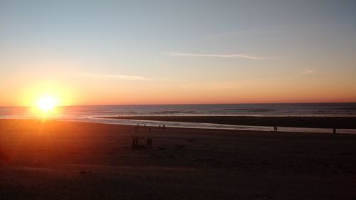 Scenic view of beach against sky during sunset