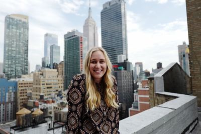 Portrait of young woman standing on walkway