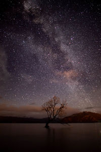 Scenic view of lake against star field at night