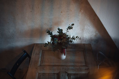 High angle view of vase with bunch of flowers on table