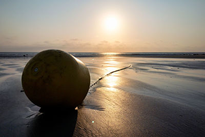 Buoy at the beach during sunset