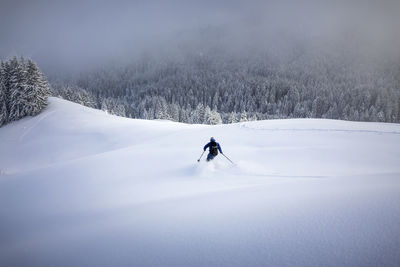 Mid adult man skiing on snowcapped mountain during winter