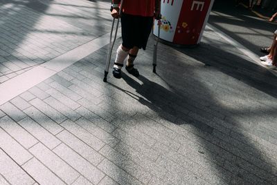 Low section of people walking on road