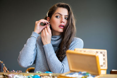 Portrait of beautiful young woman with tattoo on table