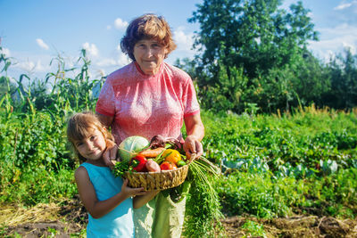 Portrait of smiling young woman picking plants