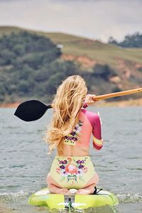 Girl standing on beach against sea