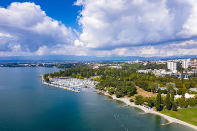 High angle view of buildings and sea against sky