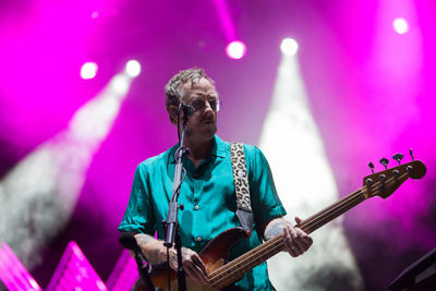 Woman playing guitar at music concert
