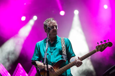 Woman playing guitar at music concert