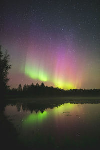 Scenic view of lake against sky at night