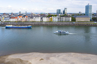 Scenic view of river and buildings in city