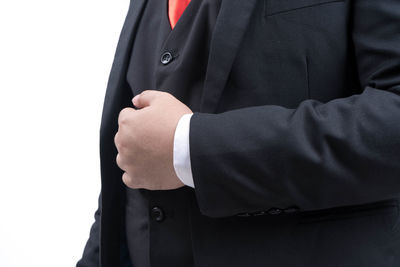 Midsection of man standing against white background