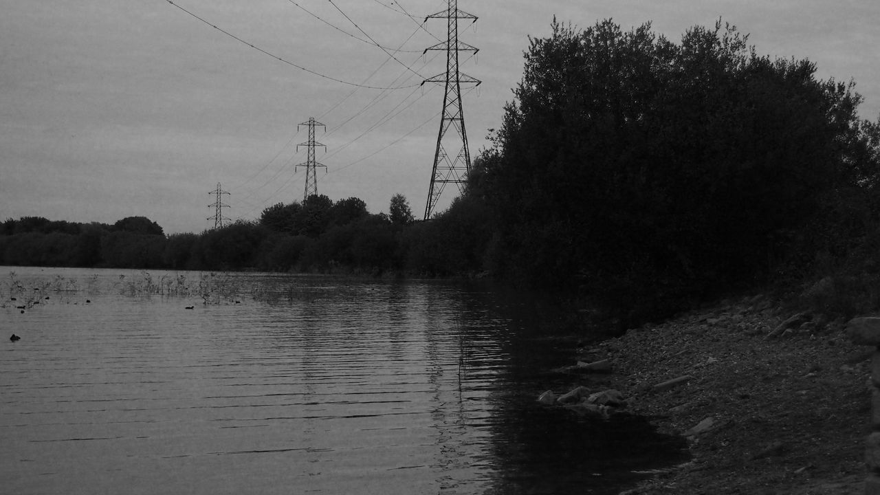 water, sky, tranquility, tranquil scene, reflection, electricity pylon, silhouette, waterfront, nature, tree, power line, river, scenics, lake, beauty in nature, connection, outdoors, no people, fuel and power generation, rippled