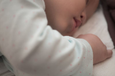 Close-up of baby sleeping on bed