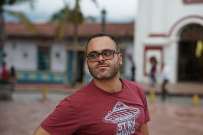 Portrait of man wearing eyeglasses standing outdoors