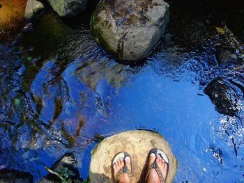 Low section of man with reflection in water