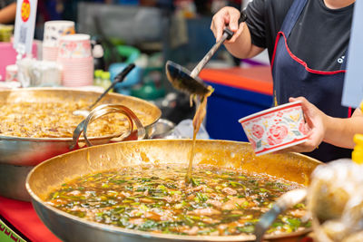 Midsection of man preparing food