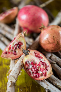 Close-up of pomegranates with sticks on table