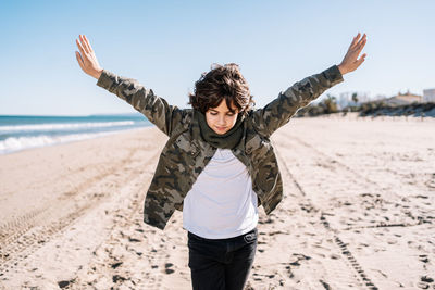 Mid adult man standing on beach