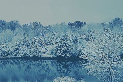 Scenic view of lake against sky during winter