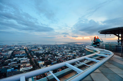 High angle view of city buildings against sky during sunset