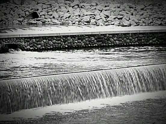 SCENIC VIEW OF WATER FLOWING IN SUNLIGHT