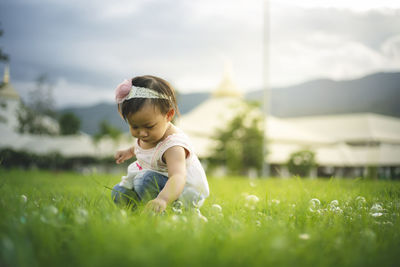 Full length of cute baby girl on field