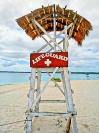 Lifeguard hut on beach against sky