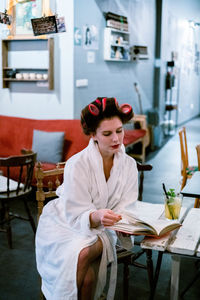 Young woman sitting on table in restaurant