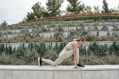 Side view of man standing against wall