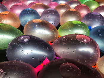 Close-up of water drops on multi colored candies