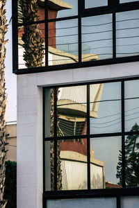 Low angle view of building seen through window