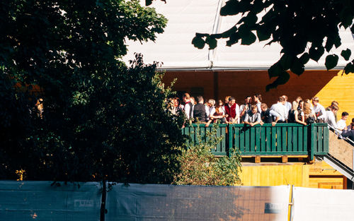 People standing by swimming pool