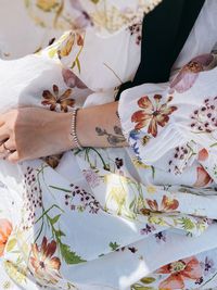 High angle view of woman hand by potted plant on bed