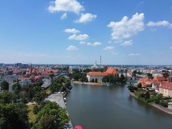 High angle view of townscape by sea against sky