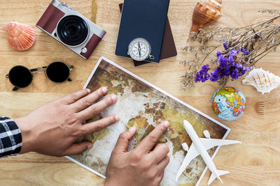 High angle view of hand holding ice cream on table