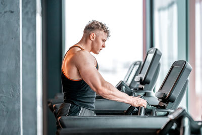 Young man exercising in gym