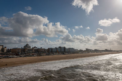 Panoramic view of beach and buildings against sky