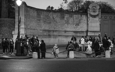 People standing by street in city