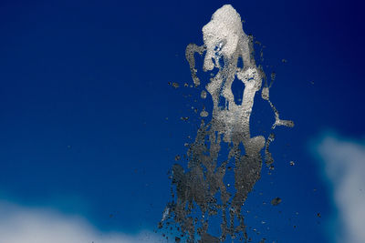 Low angle view of fountain against sky