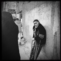 Woman standing by wall