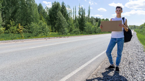 Rear view of man walking on road