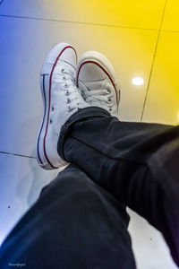 Low section of man sitting on tiled floor