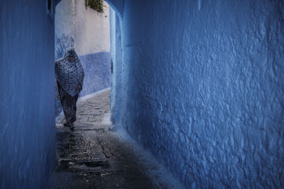 People in sea against blue wall